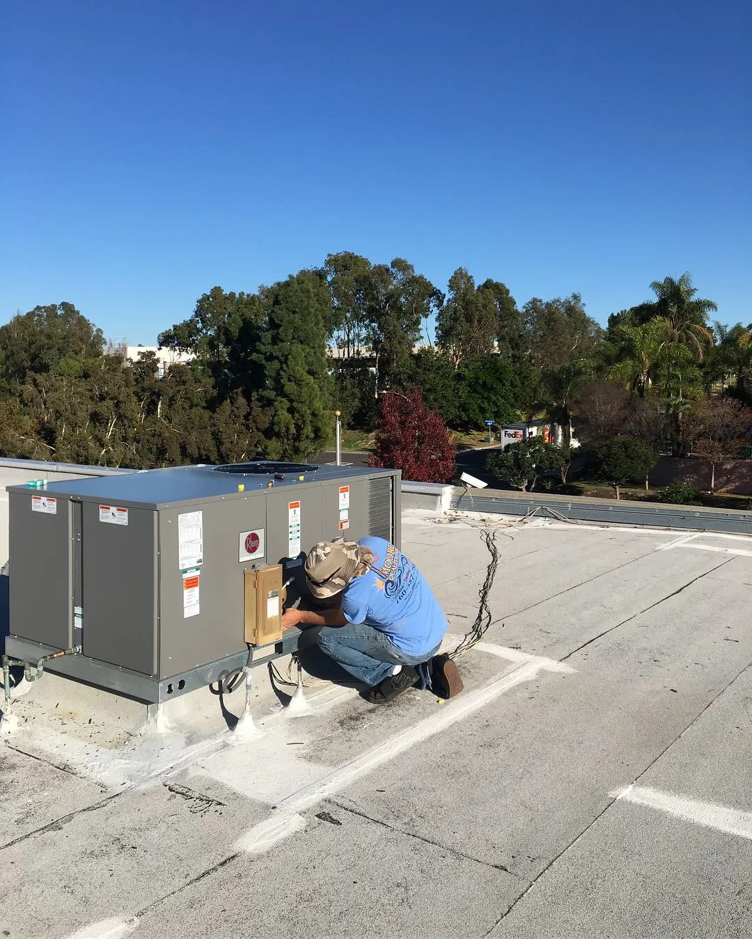 Technician servicing a rooftop unit