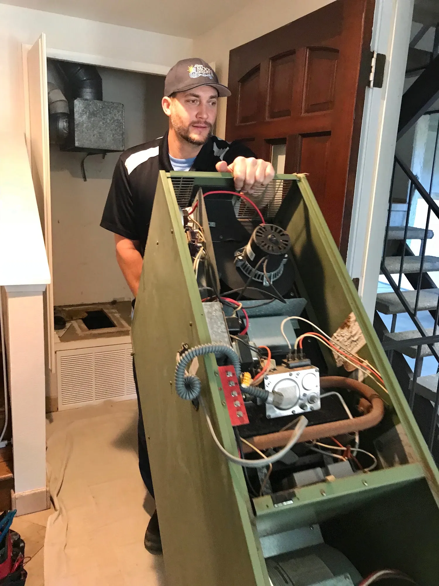 Steve Moore hauling out an old furnace during a replacement